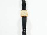 a close up of a watch on a white surface with a white background