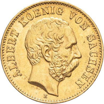 gros plan d'une pièce d'or sur laquelle figure le visage d'un homme