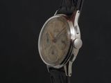 a close up of a watch on a black background