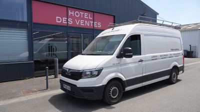 La camionnette blanche est garée devant l'Hôtel des Ventes.