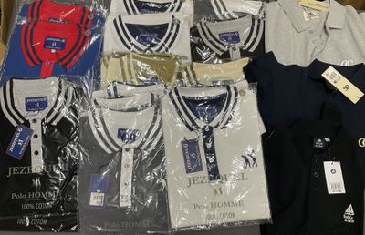 a lot of t - shirts that are sitting on a table