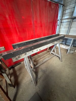 a red wall behind a bench in a building