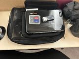 a laptop sitting on top of a bag on a desk