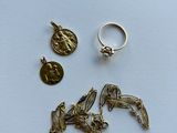 two rings, a coin, and a ring with a bird on it