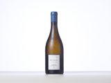 a bottle of white wine sitting on top of a table