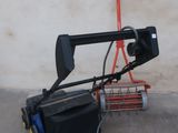 a small cart with a camera attached to it next to a wall