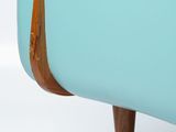 a close up of a blue couch with wooden legs
