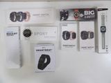 several smart watches are displayed on a white surface in a store