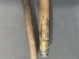 two baseball bats sitting next to each other on a table