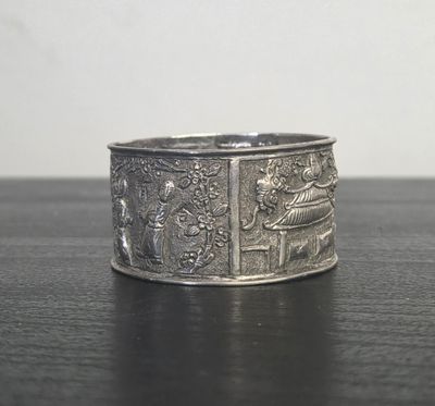 a close up of a silver ring on a table
