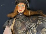 a statue of a woman dressed in armor holding a shield