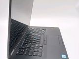 a laptop that is open on a white surface