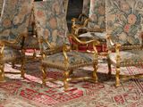 four chairs that are sitting on a rug in a room