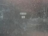 a close up of a metal plate with a number on it