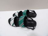 pair of black and white sandals with green and white stripes