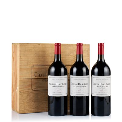 three bottles of wine in front of a wooden box