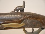 a close up of a gun with a bird on it