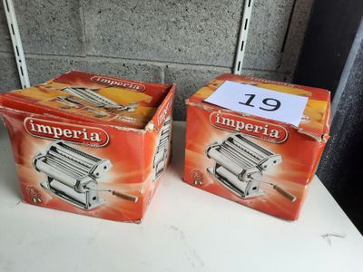 two boxes of imperia pasta sitting on a table next to each other