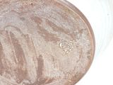 a close up of a brown and white vase on a white surface