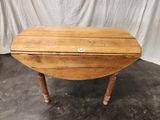 an old wooden table with a button on the top of it