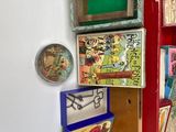 a book shelf with many books on it and a clock on the wall