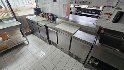 a view of a commercial kitchen with a lot of counter space