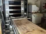 a large oven in the middle of a kitchen with a counter