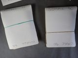 four pieces of paper with writing on them sitting on top of a table