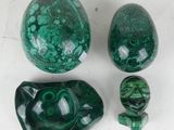 three pieces of green marble sitting next to each other on a table