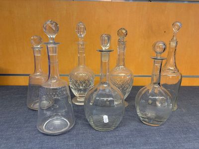 seven glass bottles with different shapes and sizes