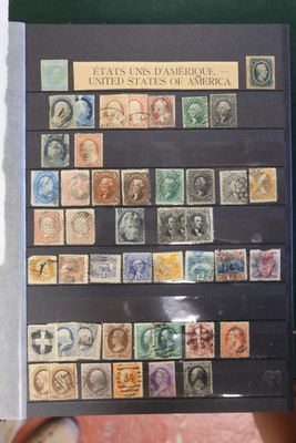 someone holding up a book with a lot of stamps on it