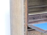 a wooden cabinet with a blue drawer in it