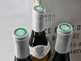 three bottles of wine sitting on a table next to each other