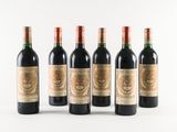 six bottles of red wine are lined up in a row