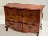 une commode en bois surmontée de quatre tiroirs