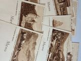 a pile of old postcards on a table