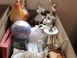 a box full of items sitting on the floor by a window