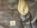 grey jacket with a yellow pocket and a checkered lining