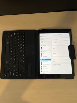 une tablette et un clavier posés sur une table