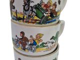 three coffee cups with cartoon characters on them stacked on top of each other