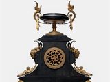 a black and gold clock sitting on top of a table