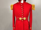 a red uniform with gold buttons and a white hat on a mannequin