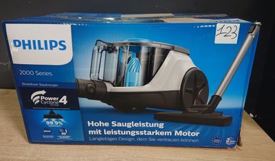 emballage d'un aspirateur Philips posé sur une table en bois