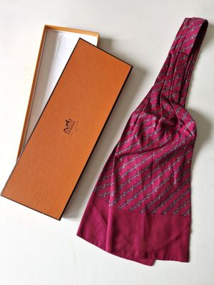 tie in a box with a tie on top of it next to a tie