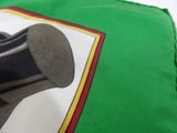 a green pillow with a picture of a hat on it