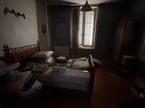 a bed in a dark room next to a window