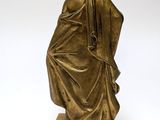 an antique bronze statue of a woman sitting on a marble base