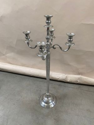 a silver candelab with three candles on it