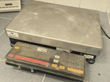 an image of a scale sitting on a tiled floor
