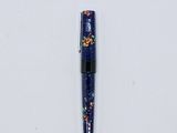 a close up of a pen on a white surface with a white background